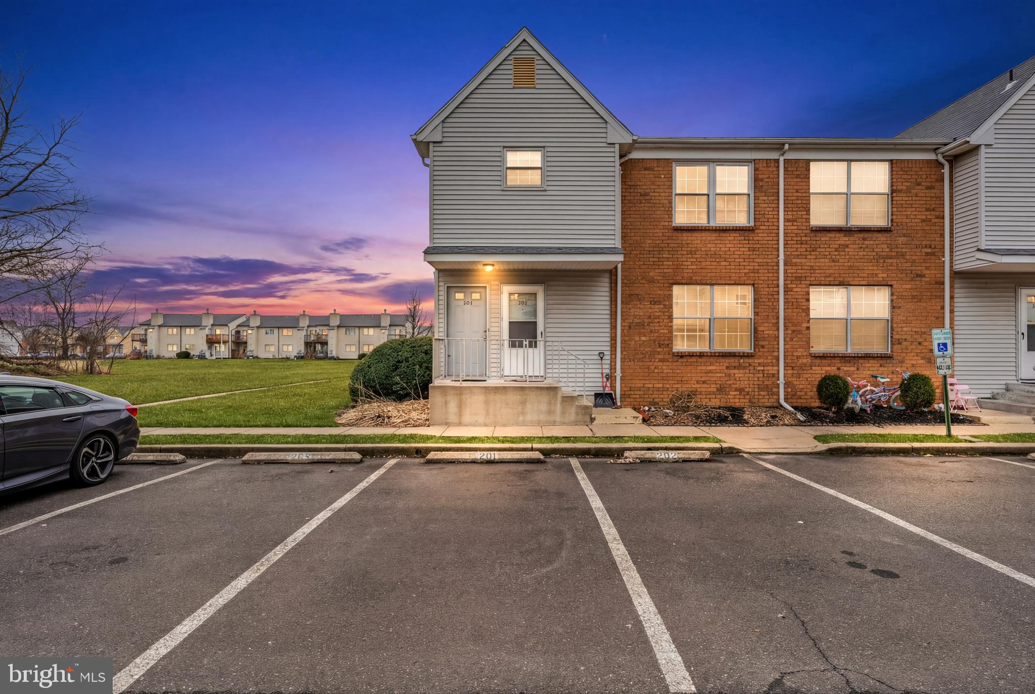 a view of building with car parked