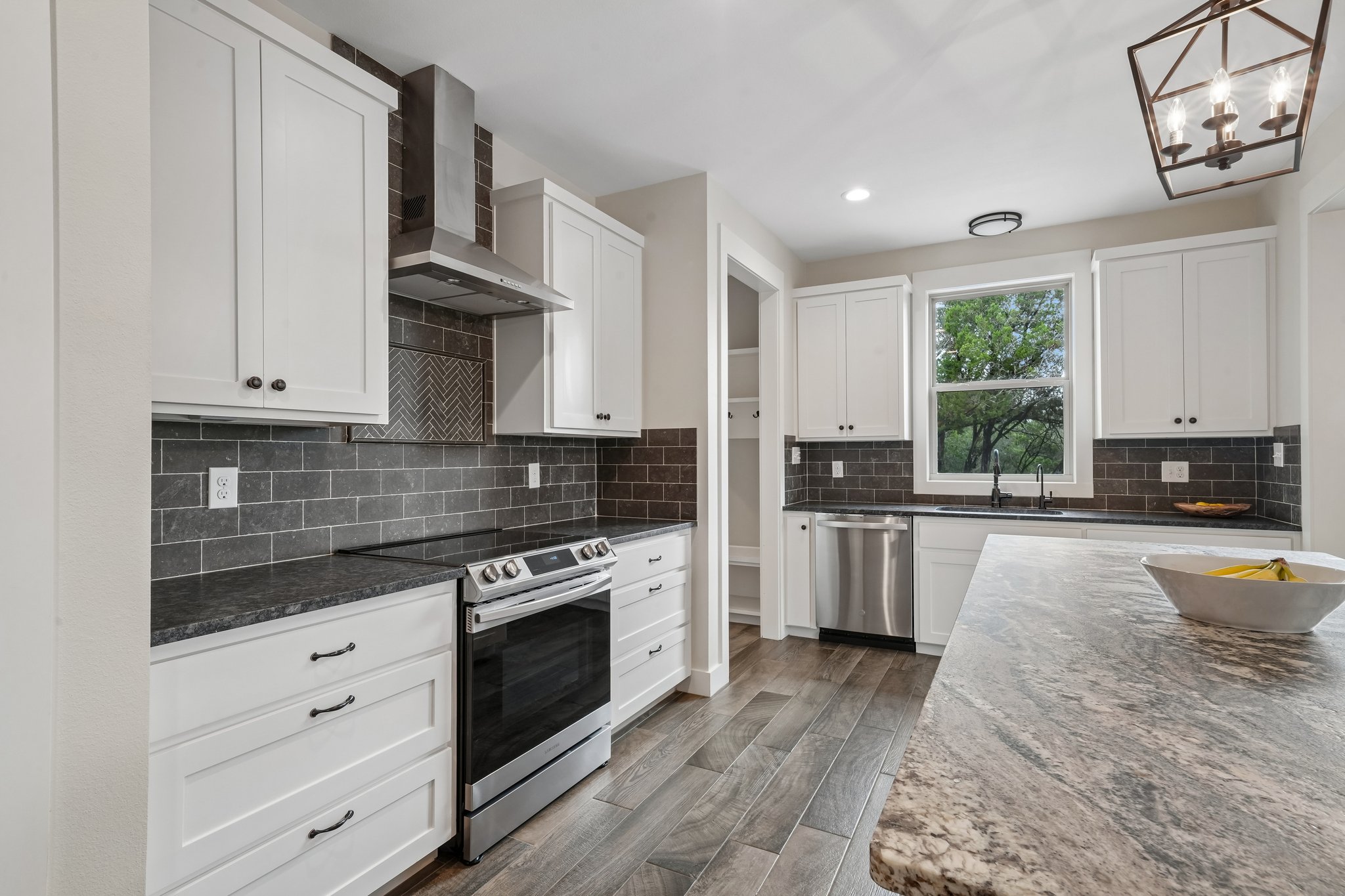 190 Magnolia Meadow Spring Branch, TX 78070 - Photo 9 of 29 A well-appointed kitchen features stainless steel appliances, granite countertops, and wood-look flooring.