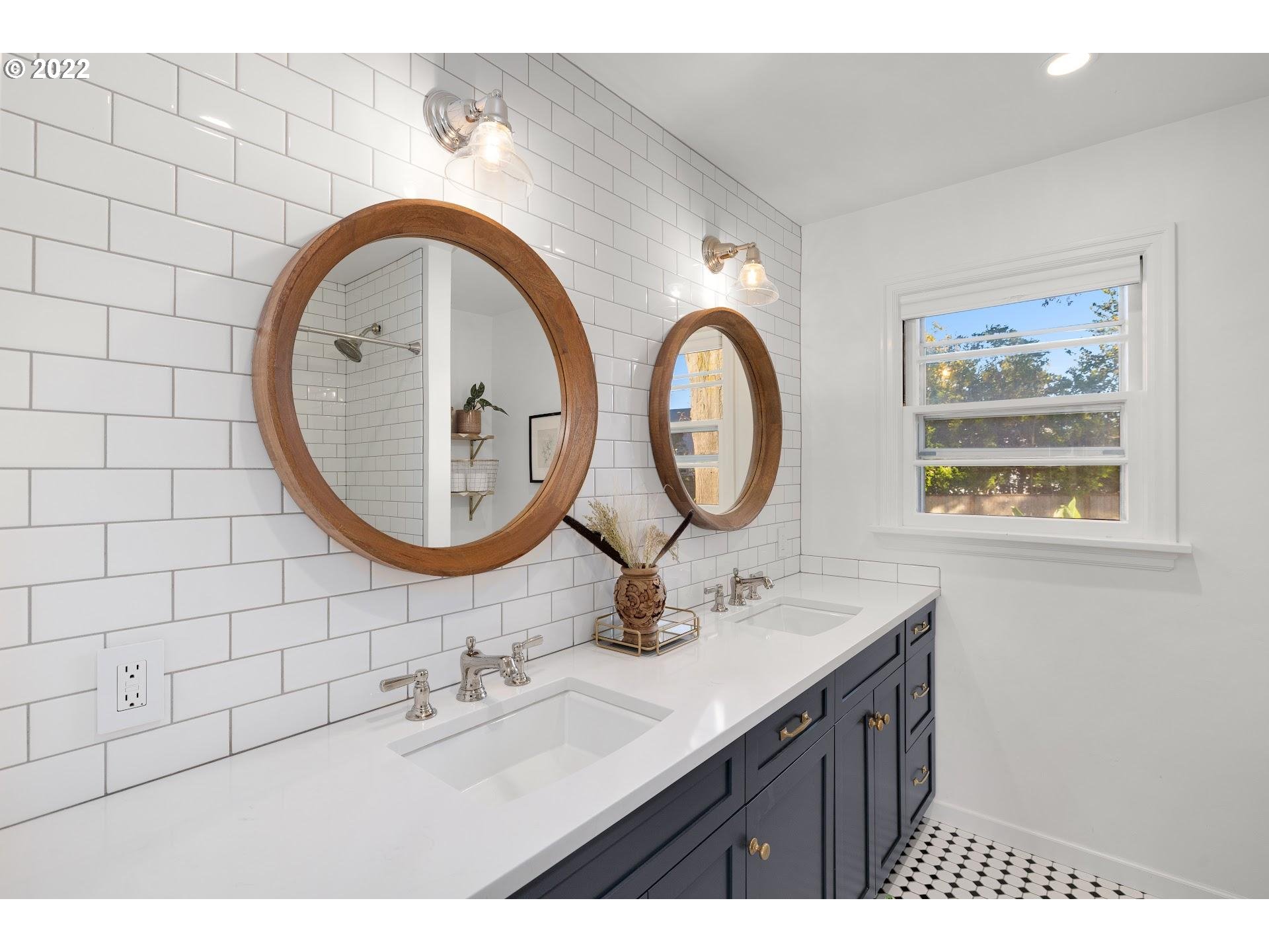 5555 Southeast Stark Street Portland, OR 97215 - Photo 14 of 21 a bathroom with a sink a mirror and a painting on the wall