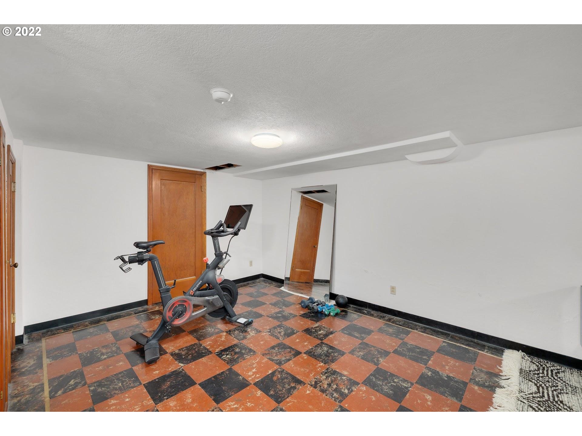 5555 Southeast Stark Street Portland, OR 97215 - Photo 18 of 21 a view of a room with gym equipment and a window