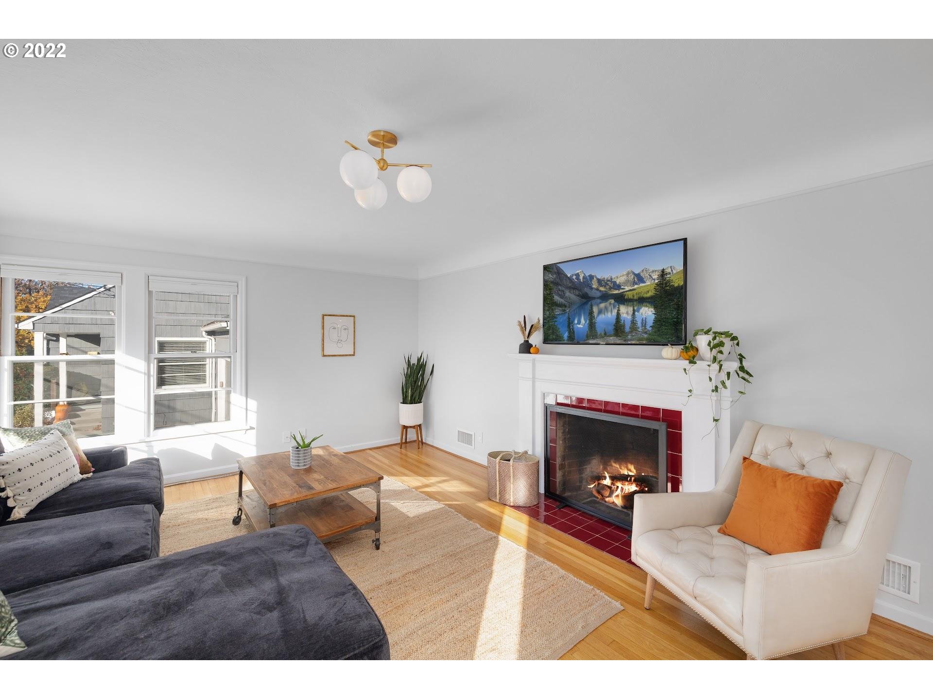 5555 Southeast Stark Street Portland, OR 97215 - Photo 4 of 21 a living room with furniture and a fireplace
