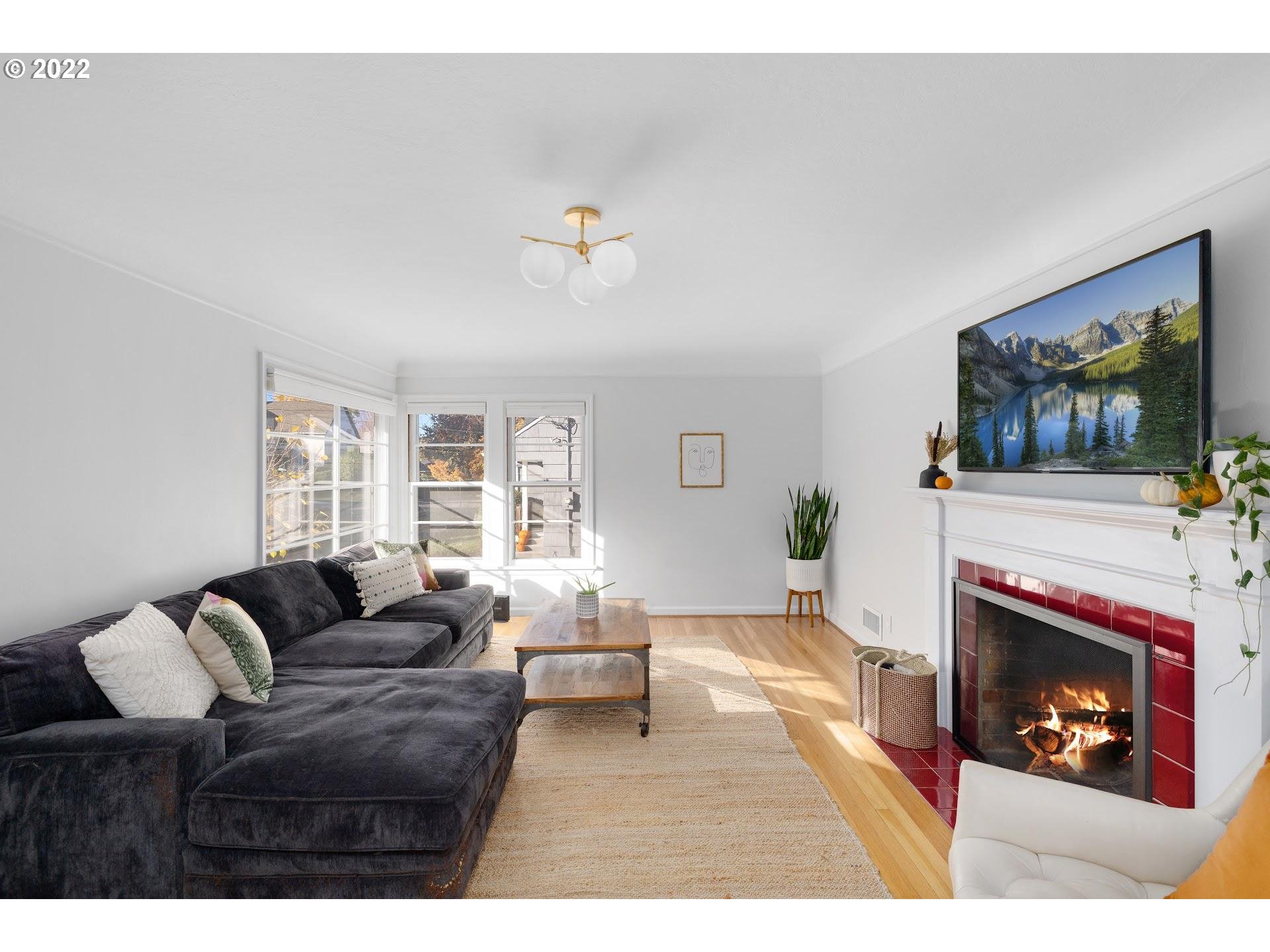 5555 Southeast Stark Street Portland, OR 97215 - Photo 5 of 21 a living room with furniture and a fireplace