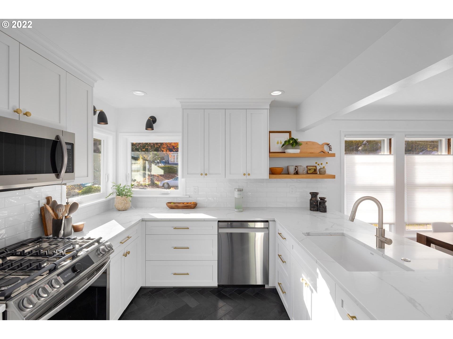 5555 Southeast Stark Street Portland, OR 97215 - Photo 10 of 21 a kitchen that has a sink and a stove in it