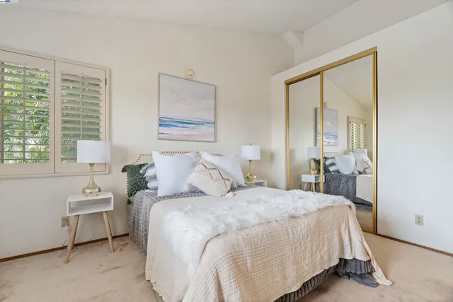 a bedroom with a bed and a large window