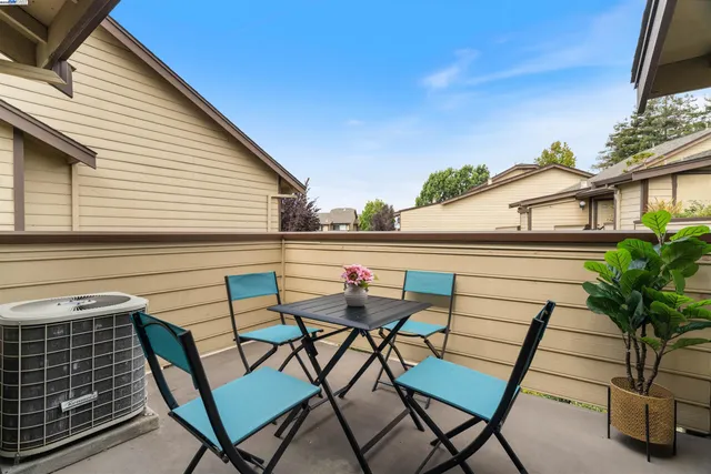 a view of a chairs and table in the balcony