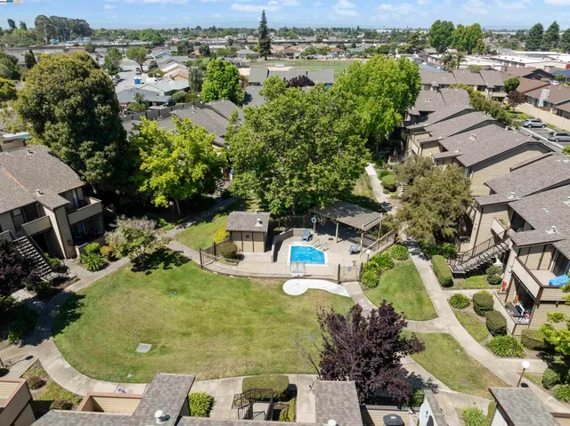 an aerial view of a house with yard swimming pool and outdoor seating
