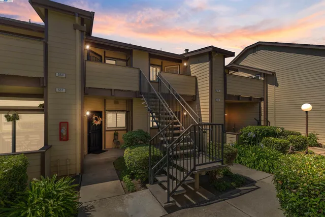 a view of a house with brick walls and plants