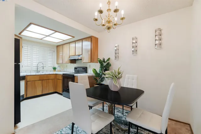 a kitchen with a table chairs and a dining table