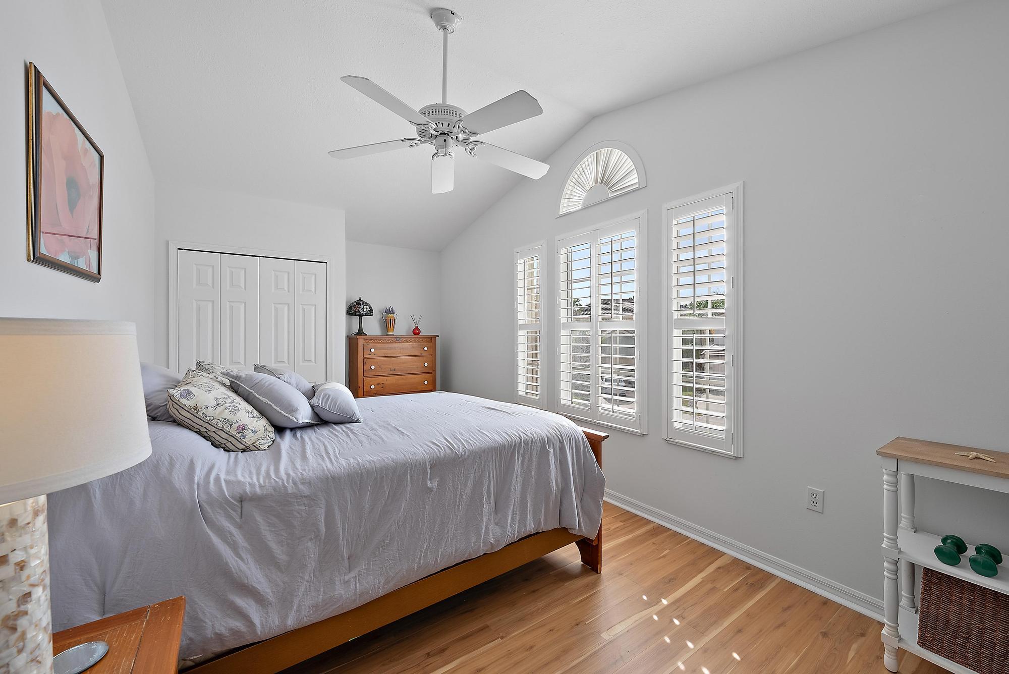 149 Stonebriar Boulevard Jupiter, FL 33458 - Photo 22 of 42 a bedroom with a bed and window