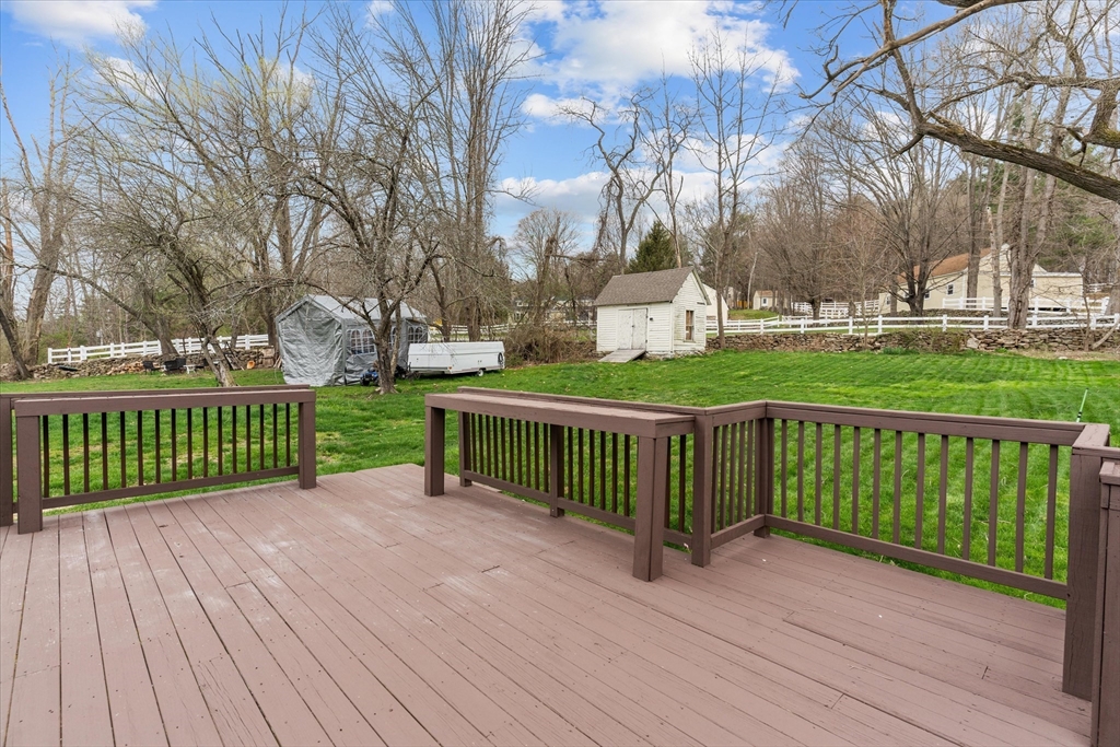 3 Douglas Road Webster, MA 01570 - Photo 18 of 24 a view of a deck with large trees and wooden fence