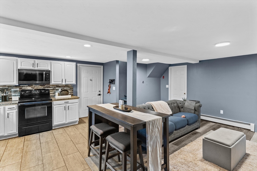 3 Douglas Road Webster, MA 01570 - Photo 2 of 24 a living room with stainless steel appliances kitchen island granite countertop a stove a sink a microwave and a refrigerator