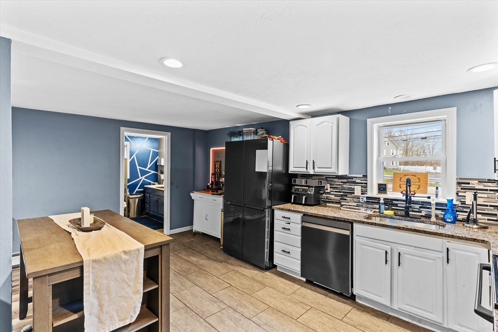 3 Douglas Road Webster, MA 01570 - Photo 3 of 24 a kitchen that has a lot of cabinets a sink and appliances in it