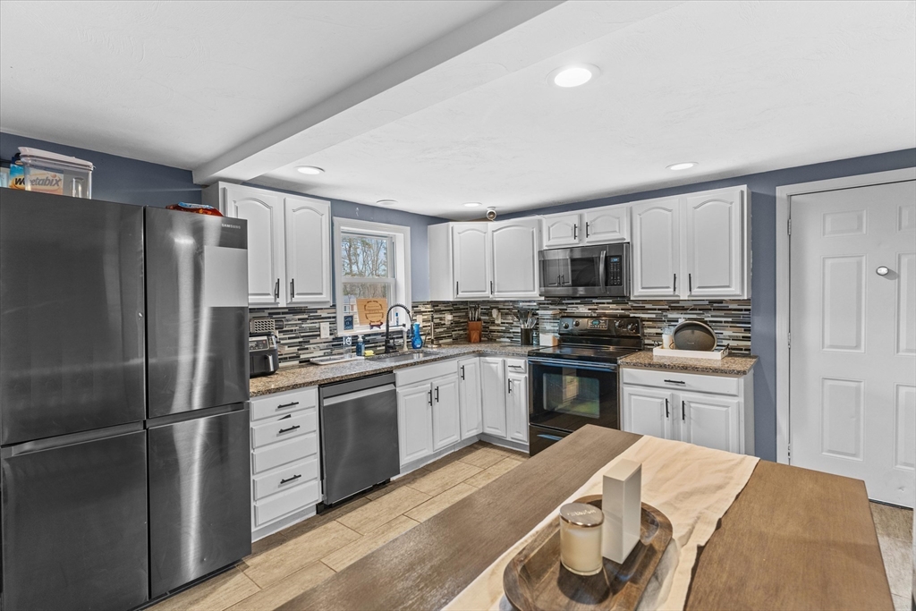 3 Douglas Road Webster, MA 01570 - Photo 4 of 24 a kitchen with stainless steel appliances granite countertop a refrigerator stove and sink