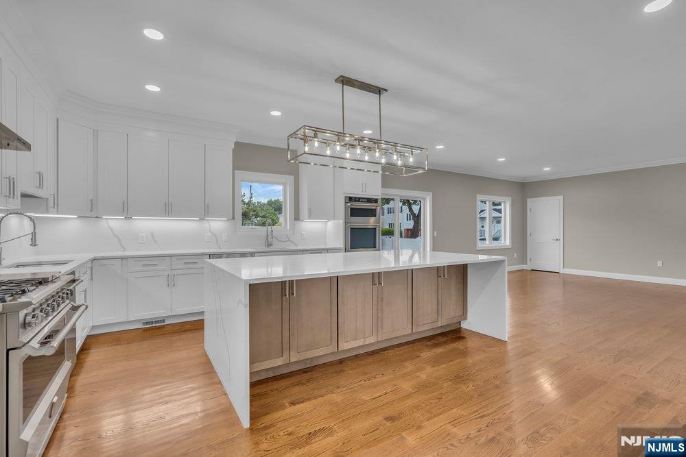 55 Maiden Lane Bergenfield, NJ 07621 - Photo 17 of 49 a kitchen with stainless steel appliances granite countertop a stove a sink and a refrigerator