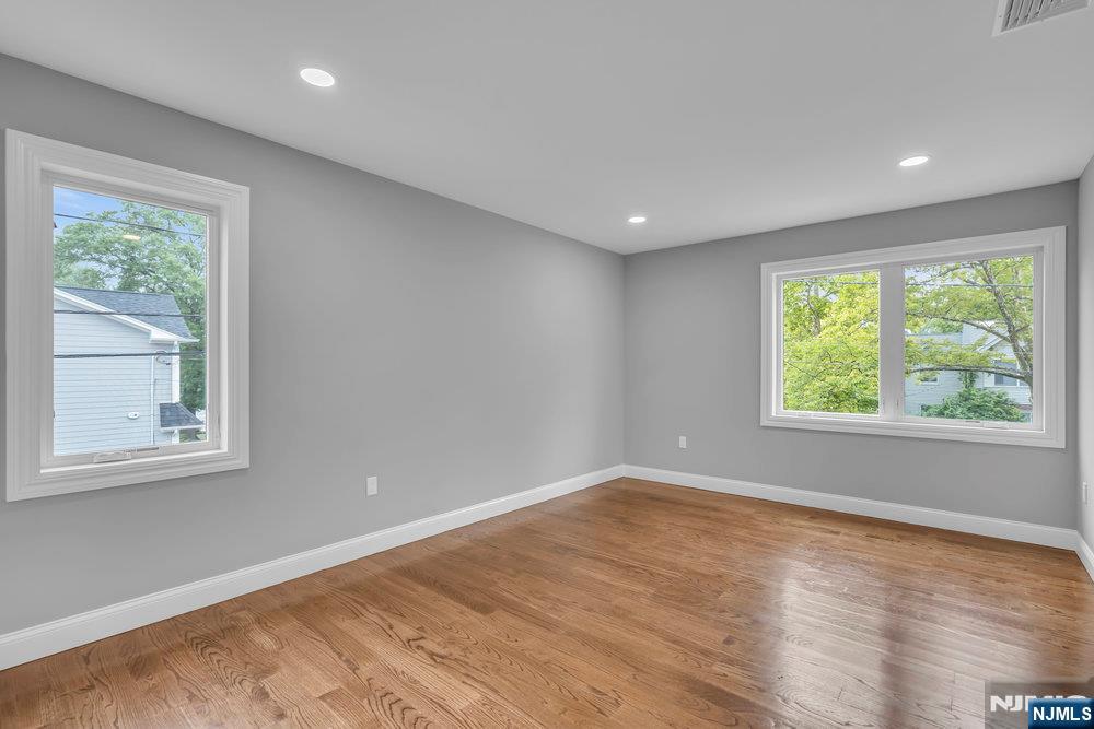 55 Maiden Lane Bergenfield, NJ 07621 - Photo 38 of 49 an empty room with wooden floor and windows