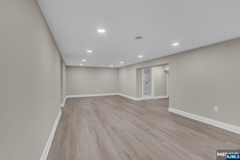 55 Maiden Lane Bergenfield, NJ 07621 - Photo 44 of 49 a view of an empty room with wooden floor and entryway