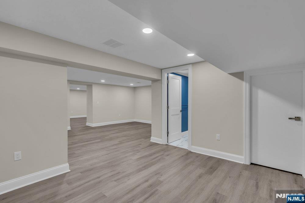 55 Maiden Lane Bergenfield, NJ 07621 - Photo 46 of 49 a view of an empty room with wooden floor