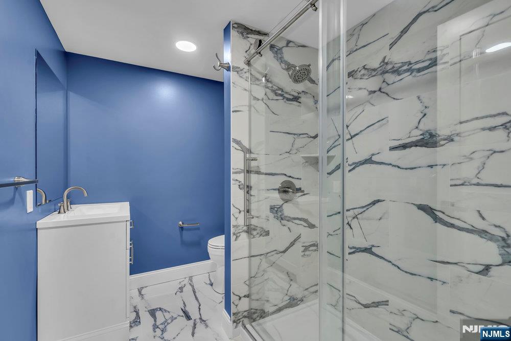 55 Maiden Lane Bergenfield, NJ 07621 - Photo 47 of 49 a bathroom with shower sink and vanity