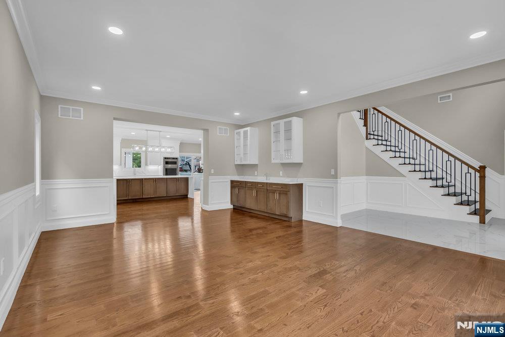 55 Maiden Lane Bergenfield, NJ 07621 - Photo 6 of 49 a view of empty room with wooden floor and kitchen