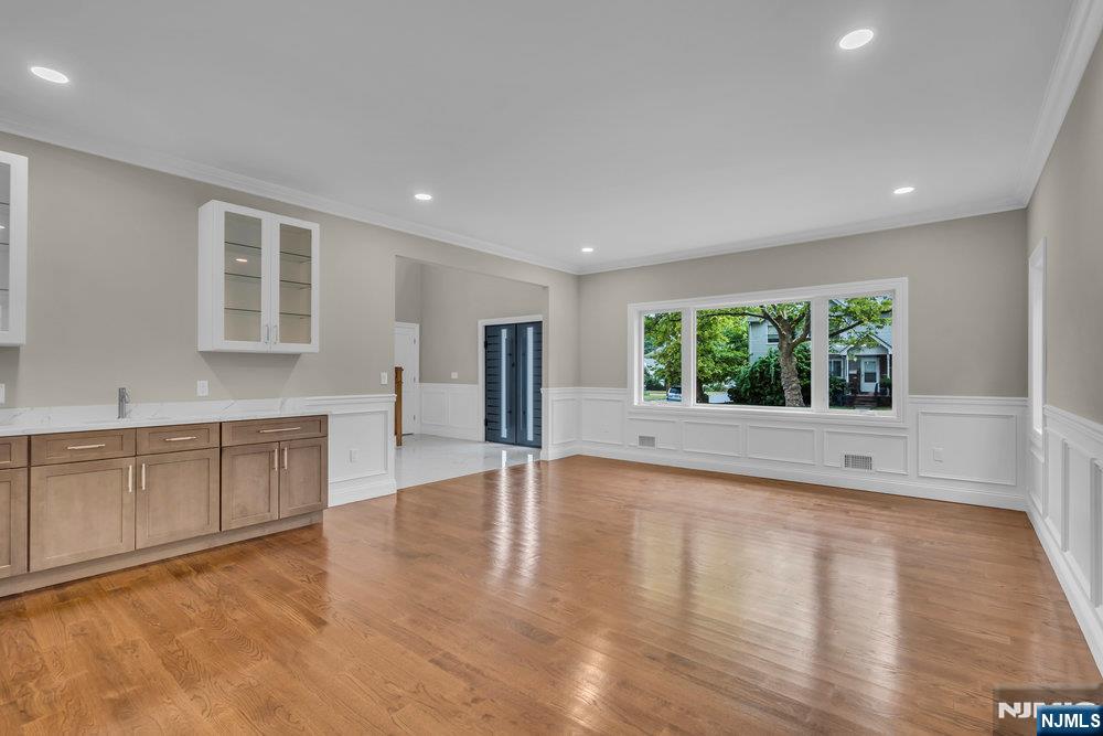 55 Maiden Lane Bergenfield, NJ 07621 - Photo 7 of 49 a view of an empty room with a window and wooden floor