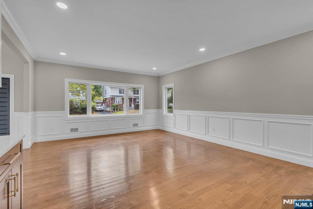 55 Maiden Lane Bergenfield, NJ 07621 - Photo 9 of 49 a view of an empty room with a window and wooden floor