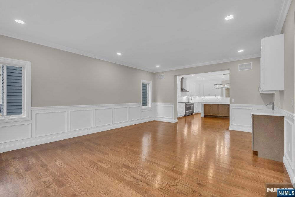 55 Maiden Lane Bergenfield, NJ 07621 - Photo 10 of 49 a view of empty room with wooden floor and fireplace