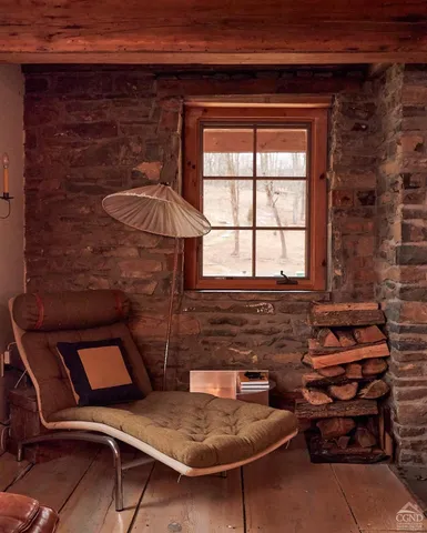 a backyard of a house with fireplace table and chairs