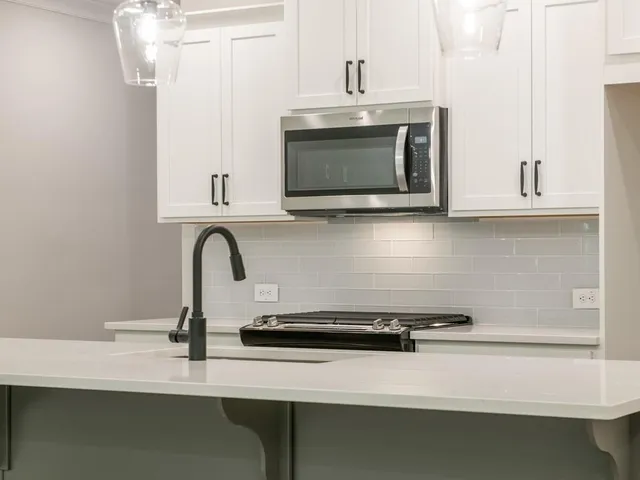 a kitchen with a sink and a microwave