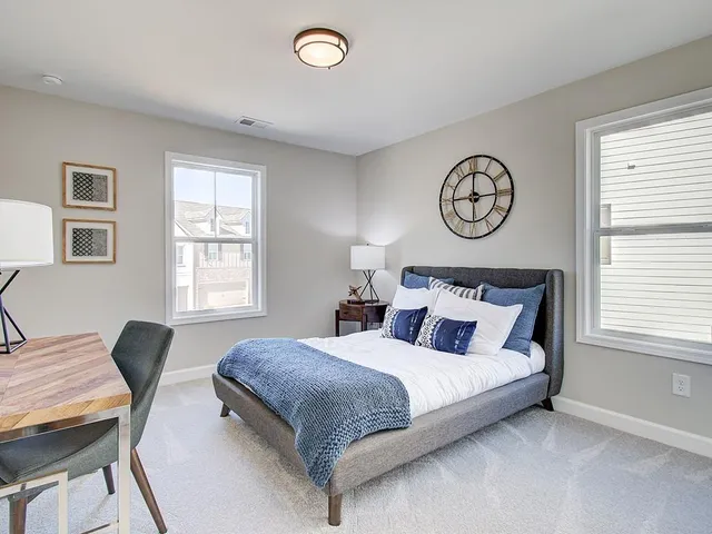 a bedroom with bed and a window