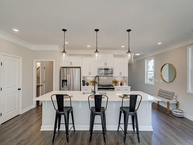 a large kitchen with a table and chairs