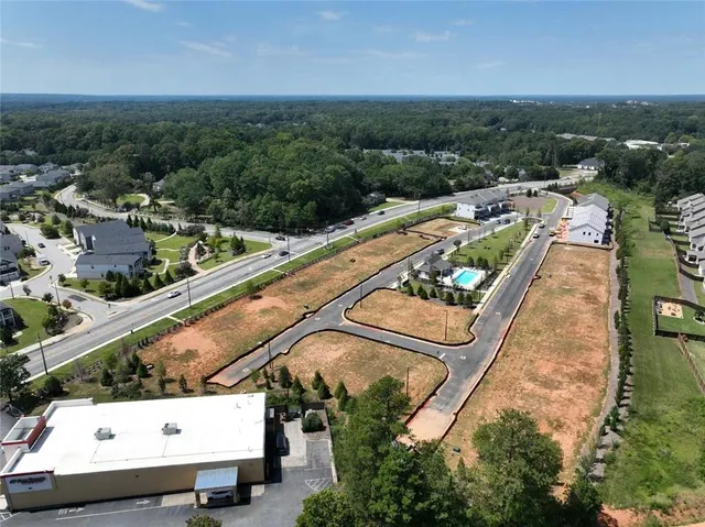 an aerial view of residential houses with outdoor space