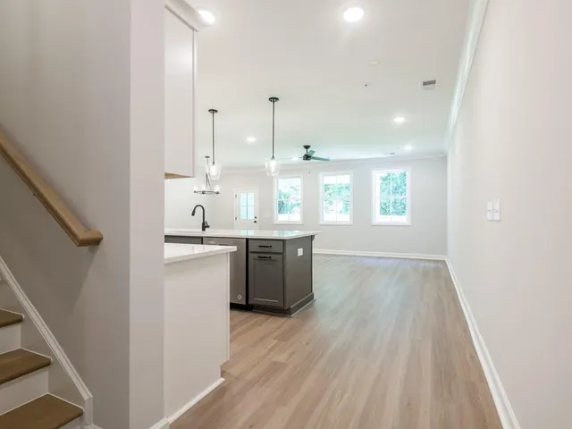a large kitchen with a lot of counter space and a wooden floor