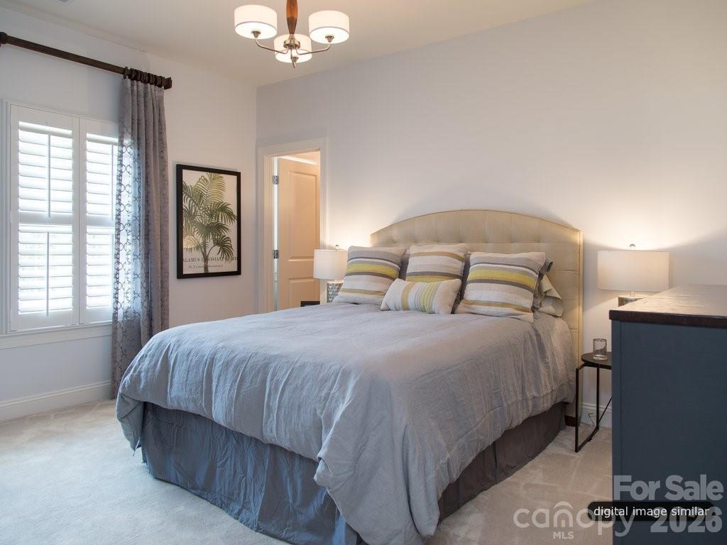 2008 Thatcher Way Fort Mill, SC 29715 - Photo 25 of 27 a bedroom with a bed and a chandelier