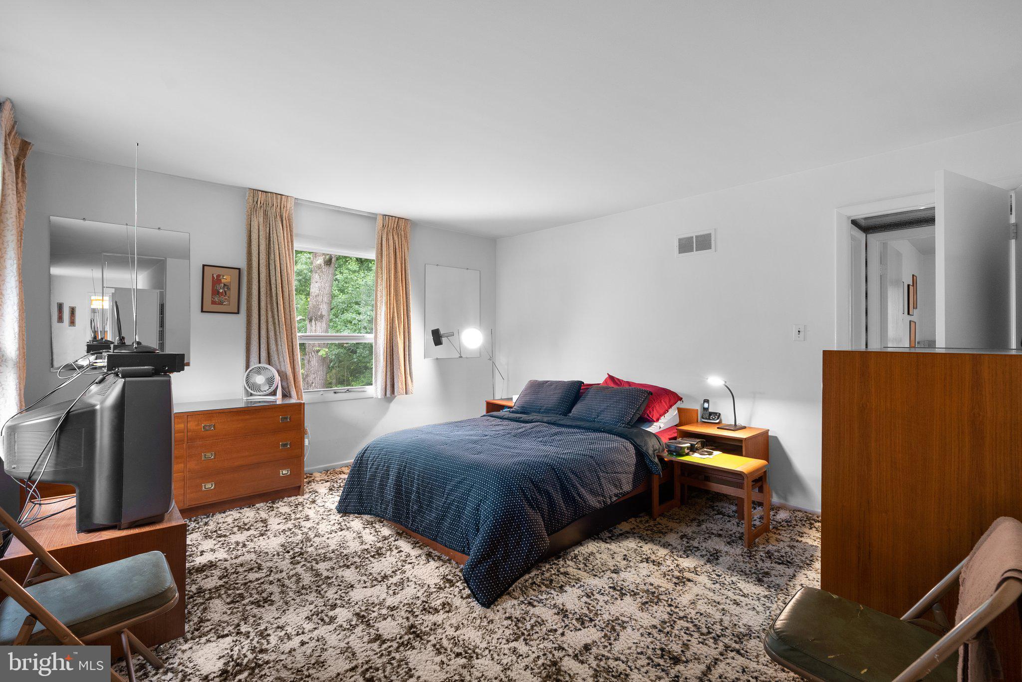 1007 La Grande Road Silver Spring, MD 20903 - Photo 20 of 48 a bedroom with a bed and a dresser with wooden floor