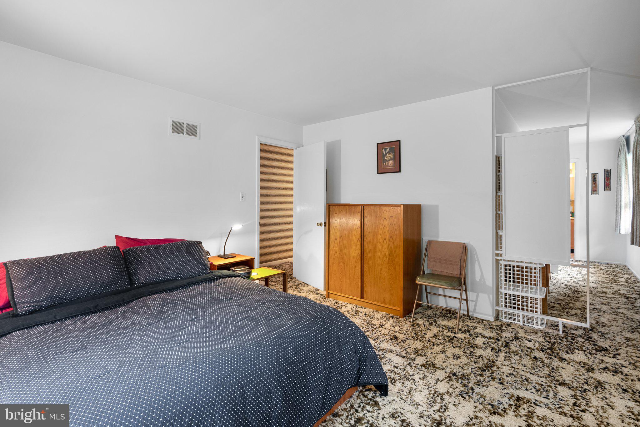 1007 La Grande Road Silver Spring, MD 20903 - Photo 21 of 48 a bedroom with a bed and dresser next to a window