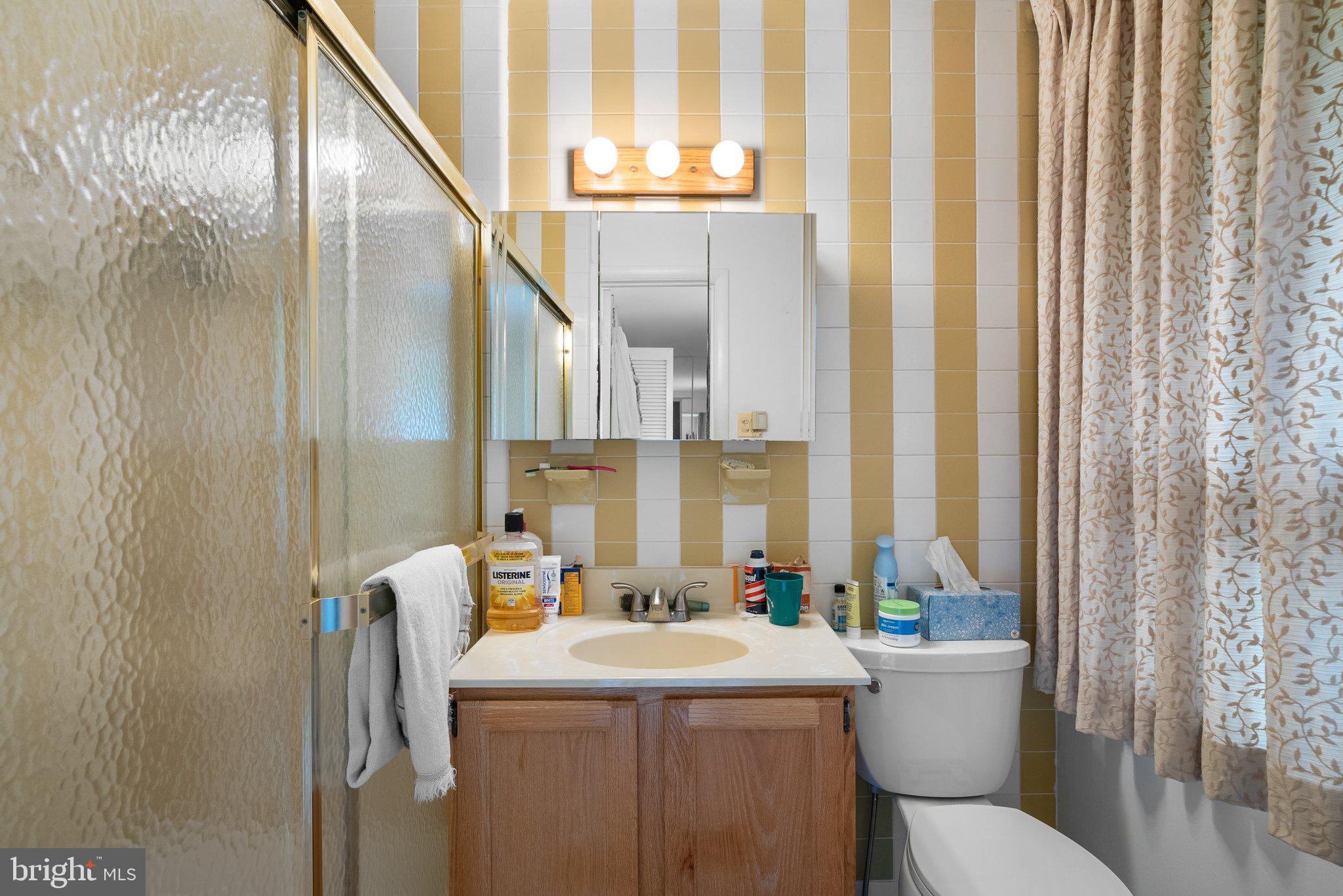 1007 La Grande Road Silver Spring, MD 20903 - Photo 23 of 48 a bathroom with a granite countertop sink and a mirror