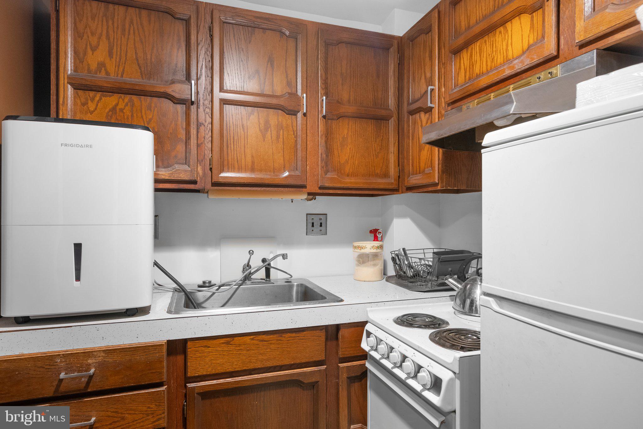 1007 La Grande Road Silver Spring, MD 20903 - Photo 36 of 48 a kitchen with a sink cabinets and appliances