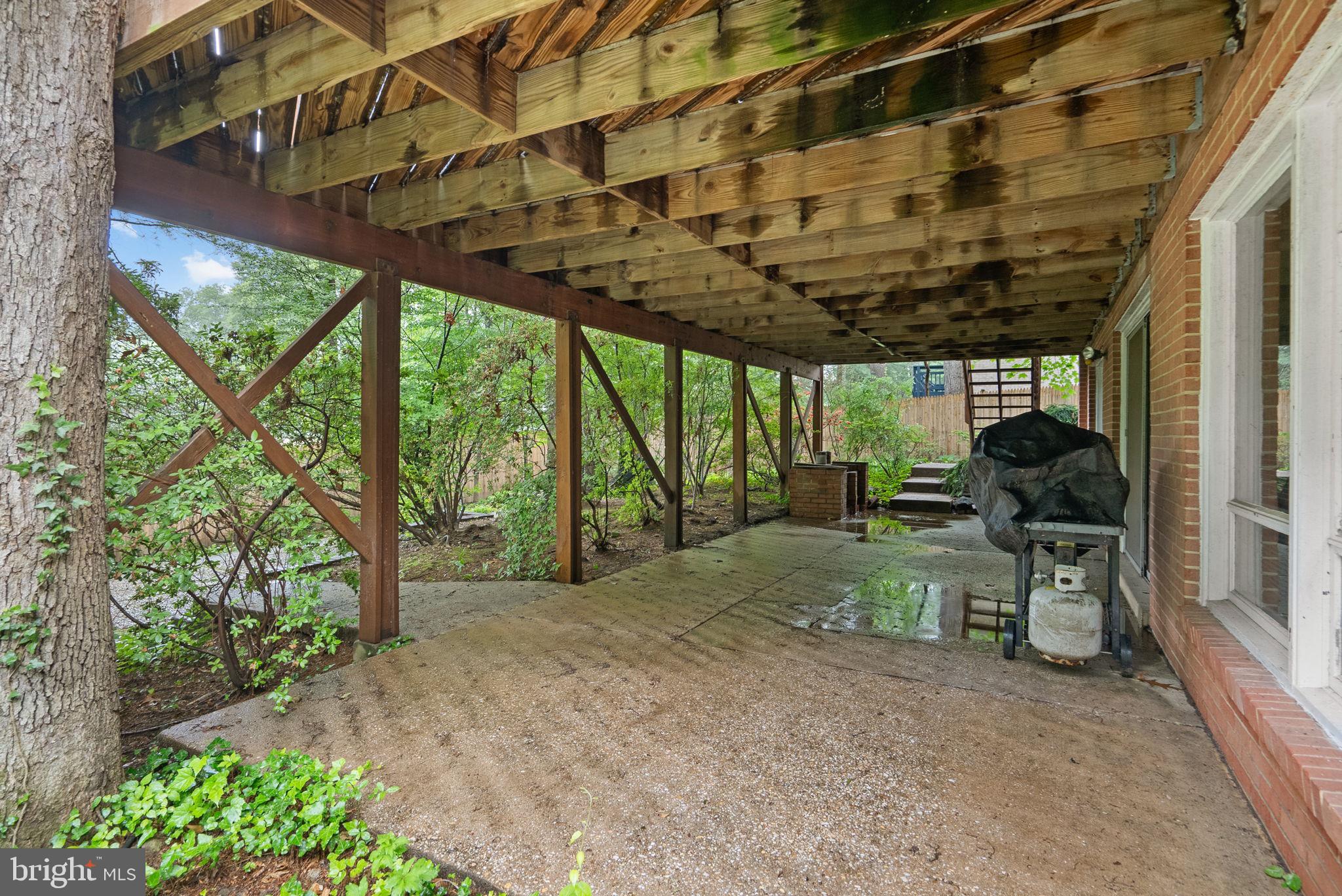 1007 La Grande Road Silver Spring, MD 20903 - Photo 41 of 48 a view of a patio with table and chairs next to a yard