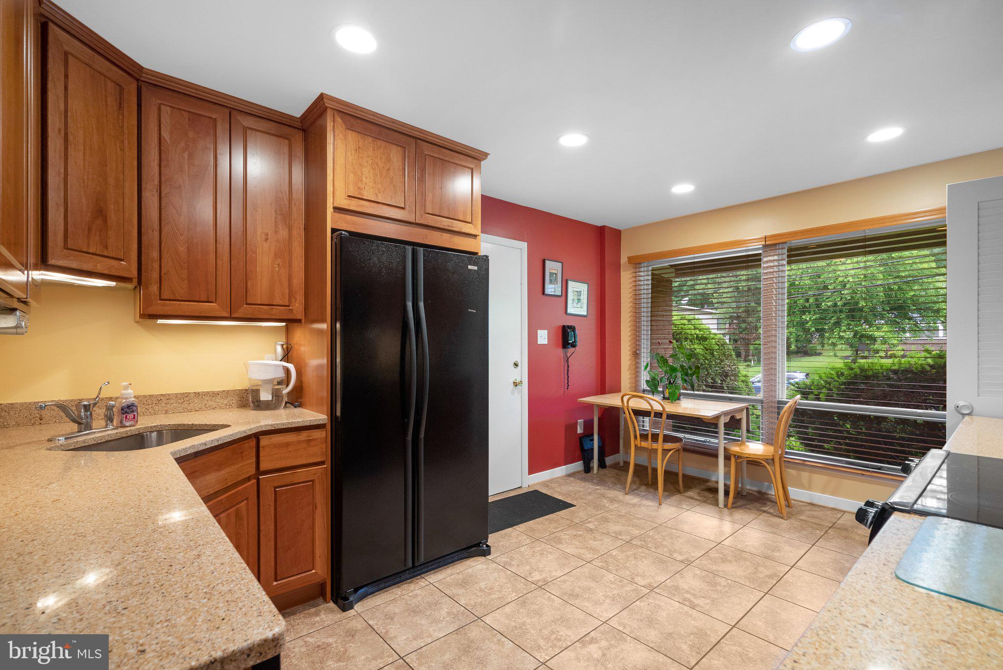 1007 La Grande Road Silver Spring, MD 20903 - Photo 7 of 48 a kitchen with granite countertop a refrigerator and furniture