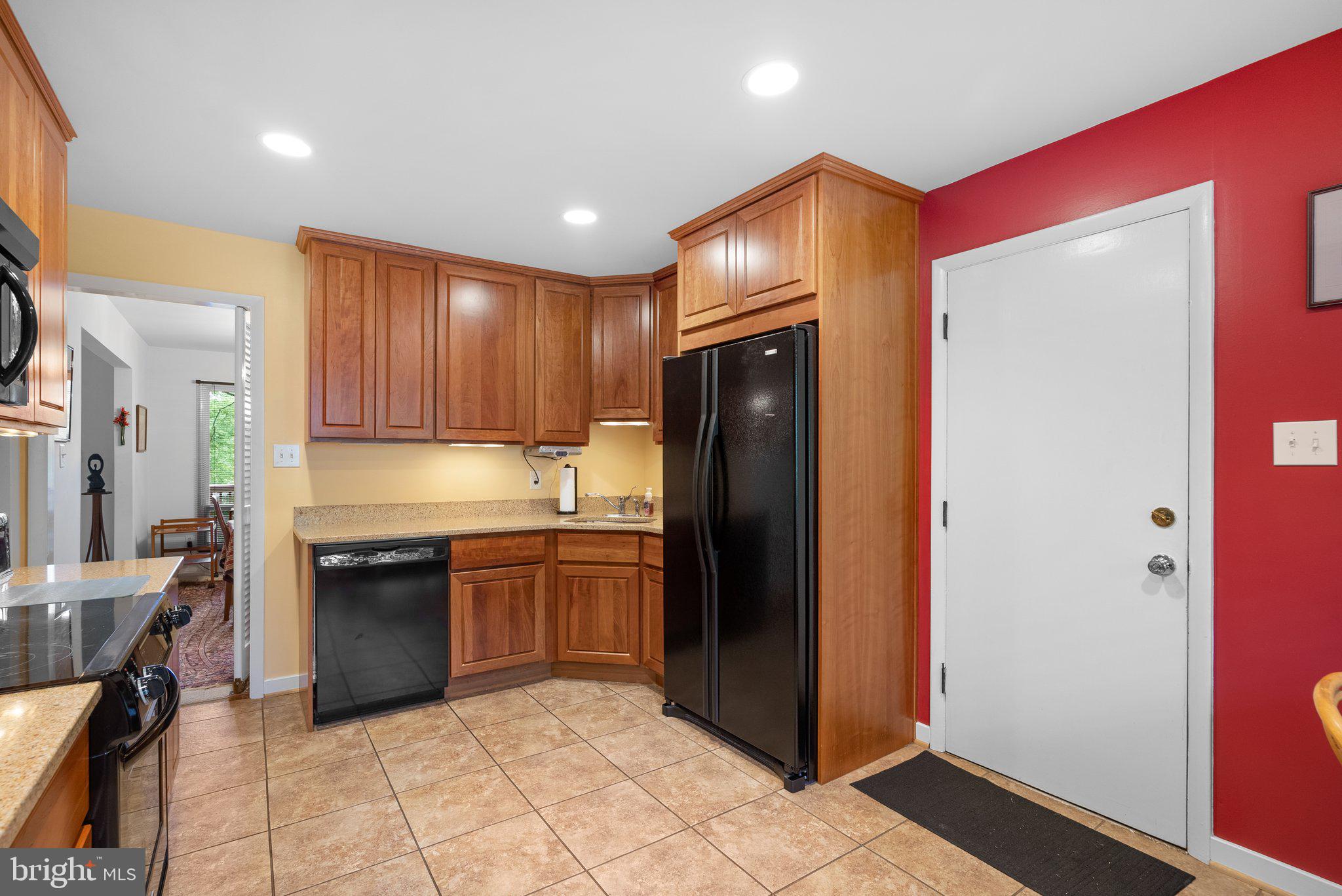 1007 La Grande Road Silver Spring, MD 20903 - Photo 8 of 48 a kitchen with stainless steel appliances granite countertop a refrigerator and a sink