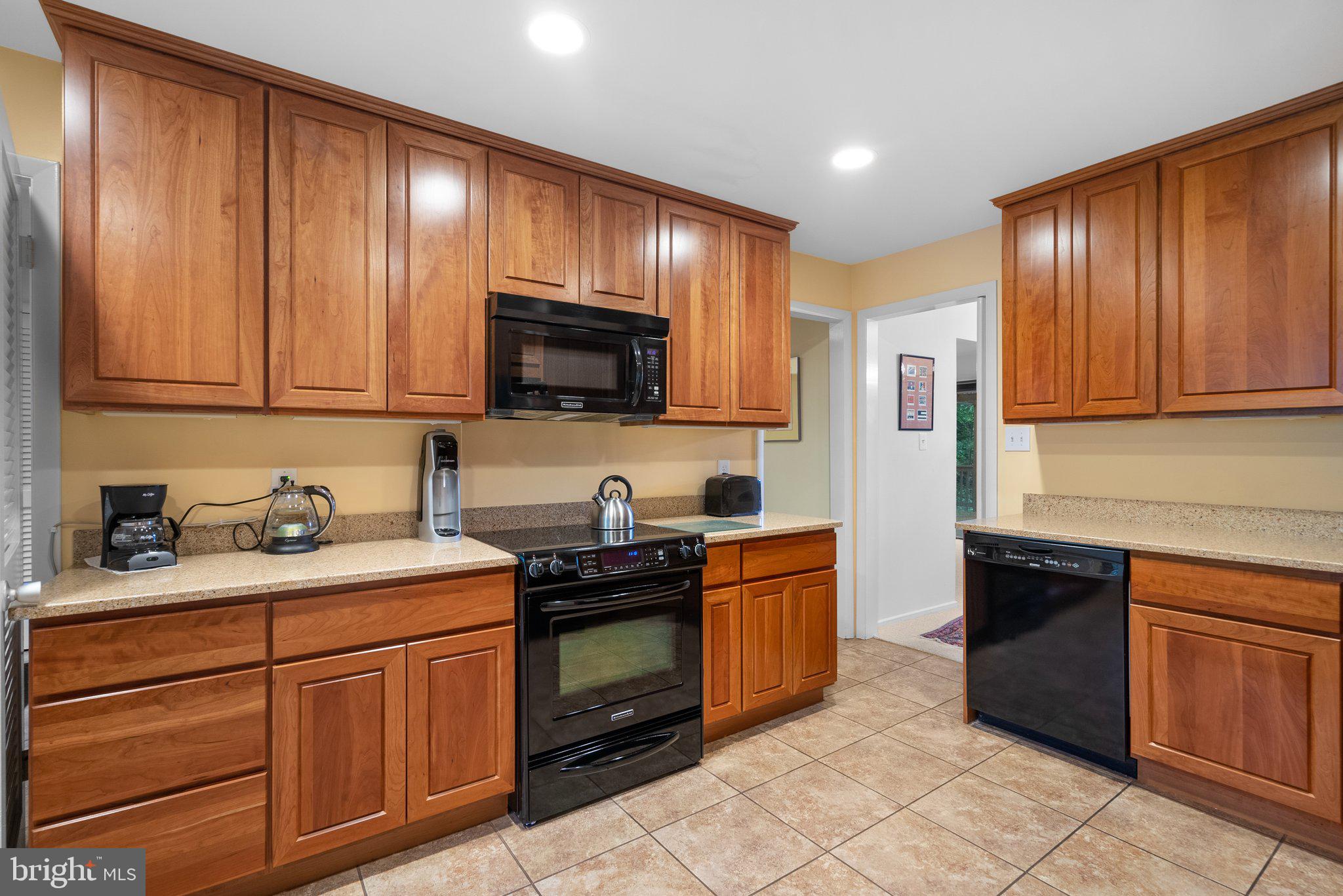 1007 La Grande Road Silver Spring, MD 20903 - Photo 9 of 48 a kitchen with stainless steel appliances granite countertop wooden cabinets a stove top oven a sink and dishwasher