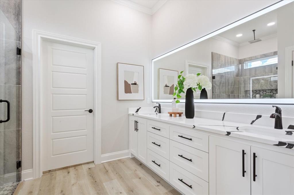 107 North Jena Street Riesel, TX 76682 - Photo 19 of 34 a bathroom with a double vanity sink and mirror