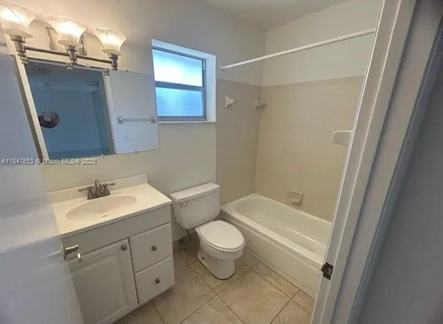 a bathroom with a sink a toilet a mirror and shower