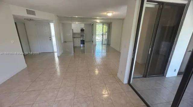 a view of a hallway with wooden shelves