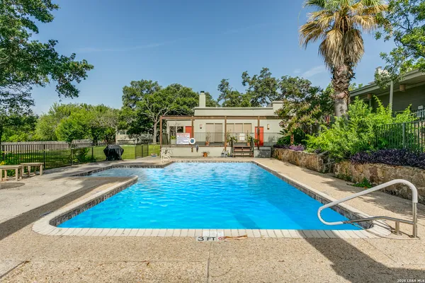 a swimming pool with outdoor seating and yard