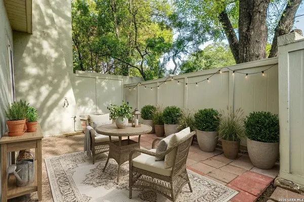 a view of a backyard with furniture and plants