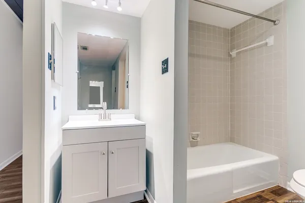 a bathroom with a tub a sink and mirror