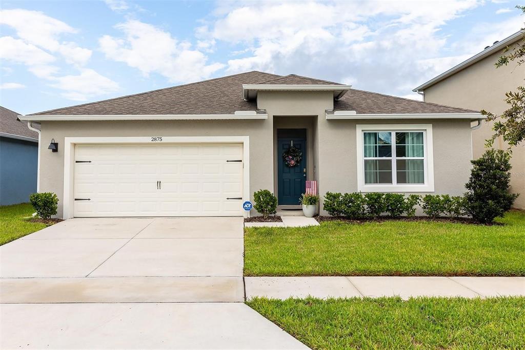 a front view of a house with a yard and garage