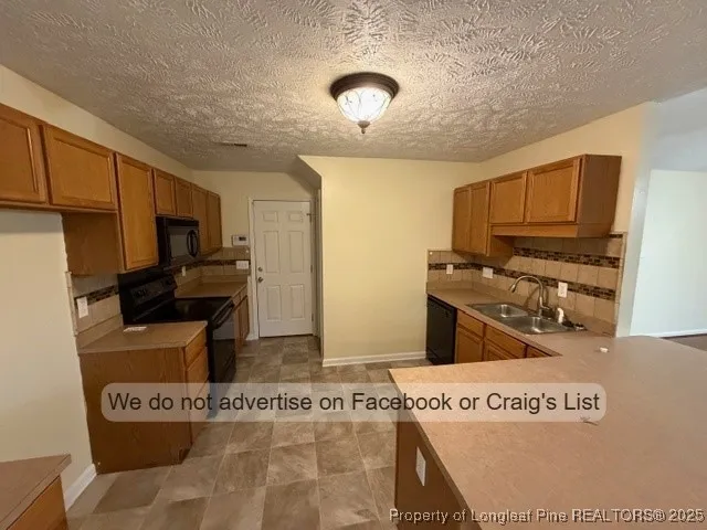 a kitchen with kitchen island cabinets and appliances