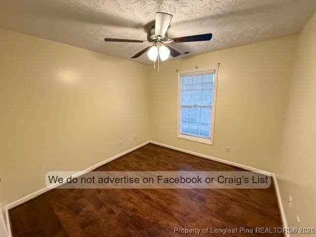 a view of a room with a ceiling fan and a window